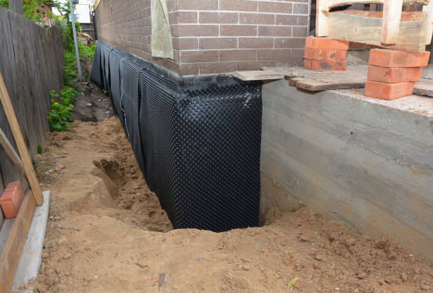 SJ Waterproofing Pros technician performing targeted Basement Waterproofing assessment in Atlantic Highlands, NJ